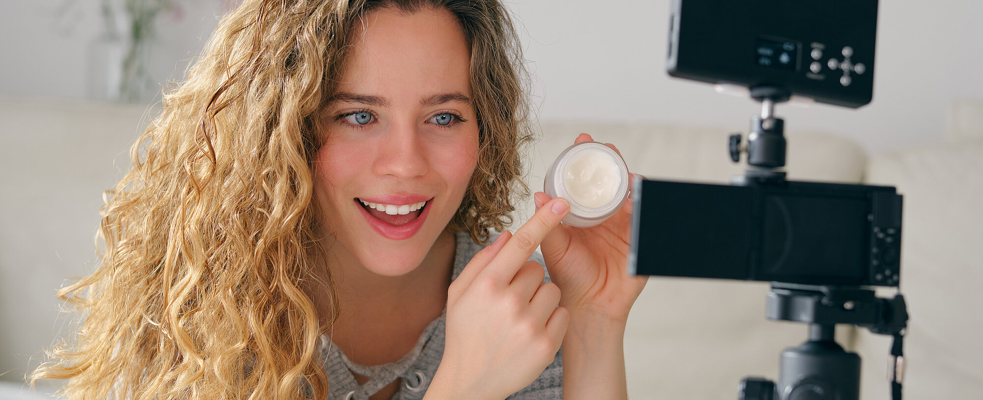 Female vlogger presenting beauty products on camera